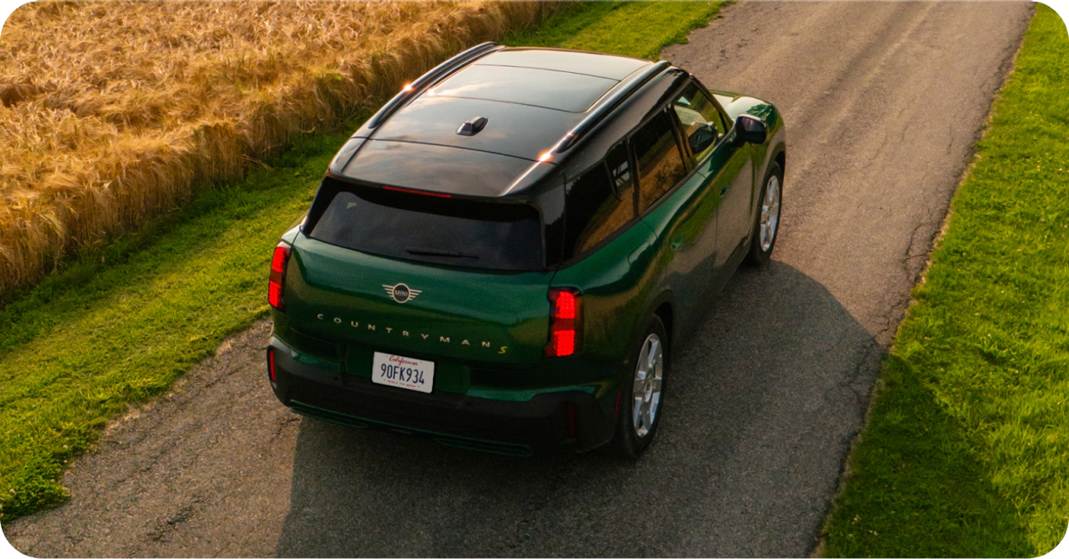 Bird’s-eye view of the MINI Countryman SE ALL4 driving down a road.