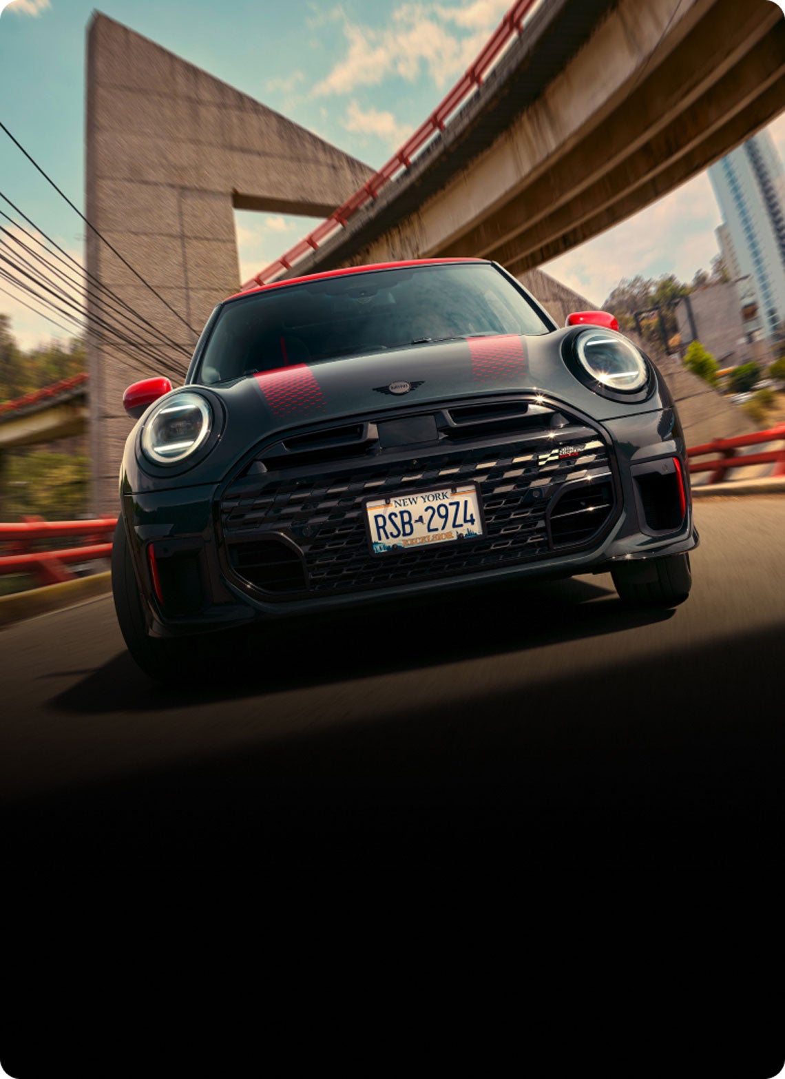 Low-angle, front view of a MINI JCW 2 Door while driving.