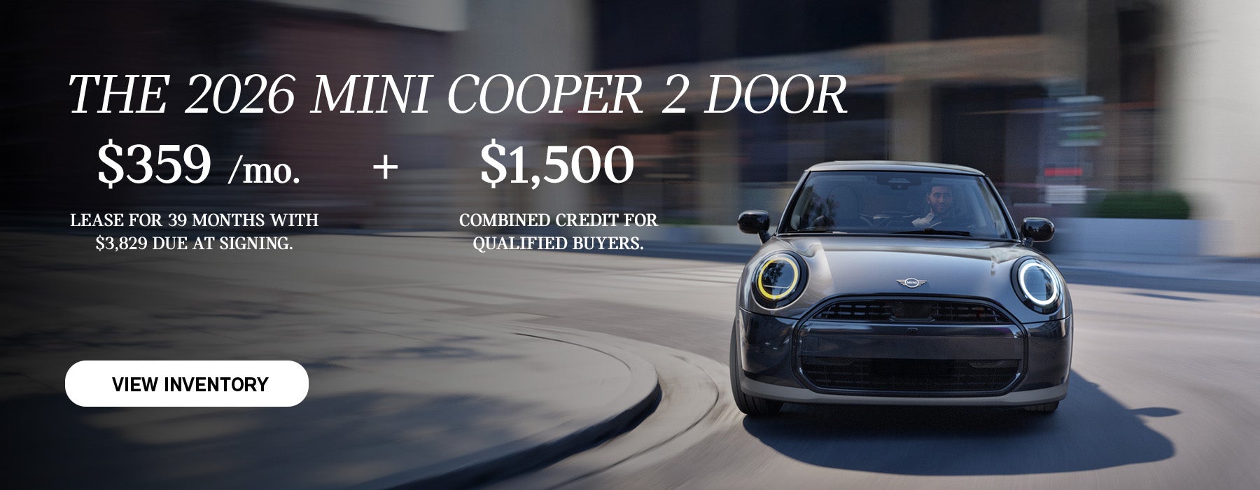 grey mini cooper driving up road