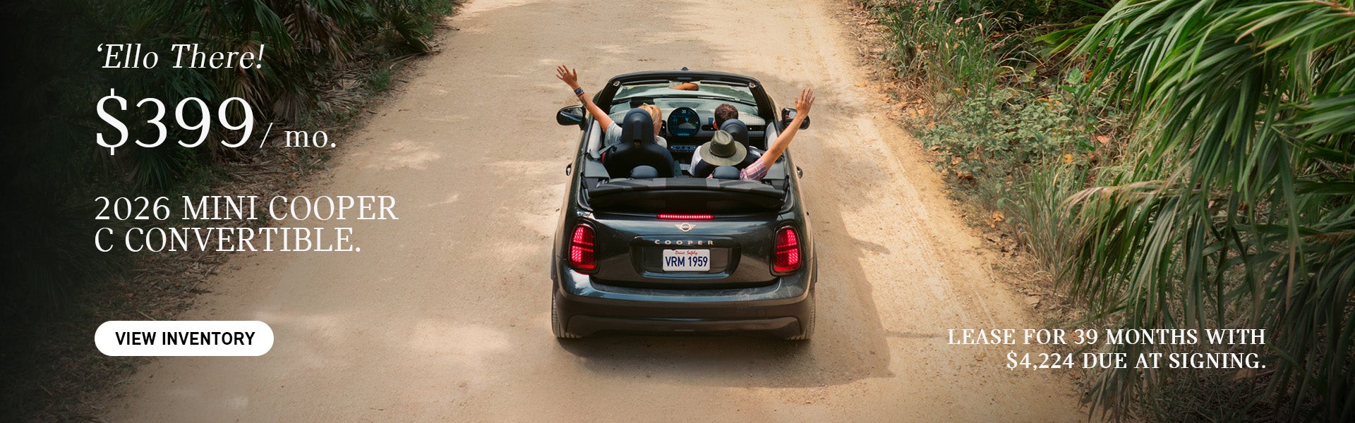 Gray MINI Convertible driving on a dirt path.