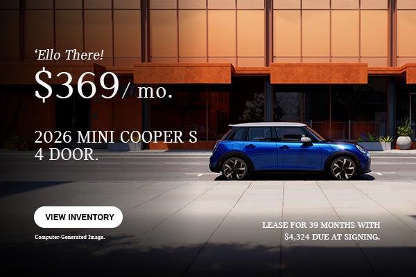 Side view of a blue MINI 4 door parked in the road.